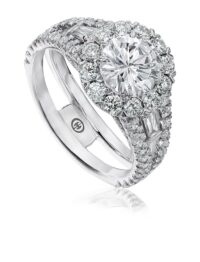 White gold halo engagement ring with tapered baguette sides and round diamonds